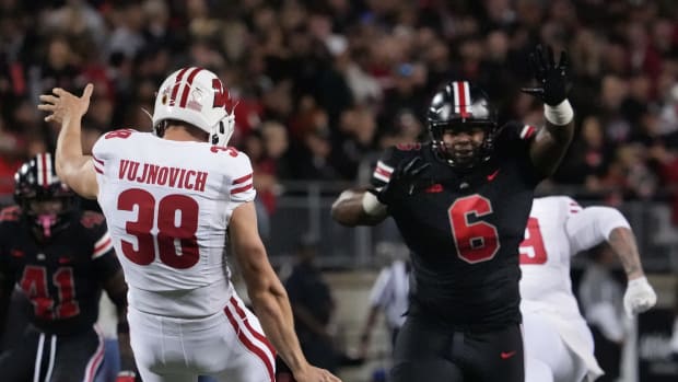 Wisconsin punter Andy Vujnovich kicking the ball against Ohio State.